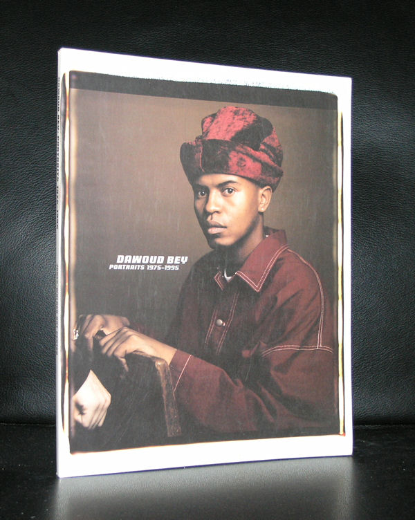Book cover featuring a portrait of Dawoud Bey, showcasing the title 'DAWOUD BEY: PORTRAITS 1975-1995'. The subject is wearing a maroon cap and a matching jacket, posed thoughtfully.