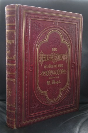 A vintage red hardcover book titled 'Die Heilige Schrift des Alten und Neuen Testaments' with intricate gold lettering and decorative embossing.