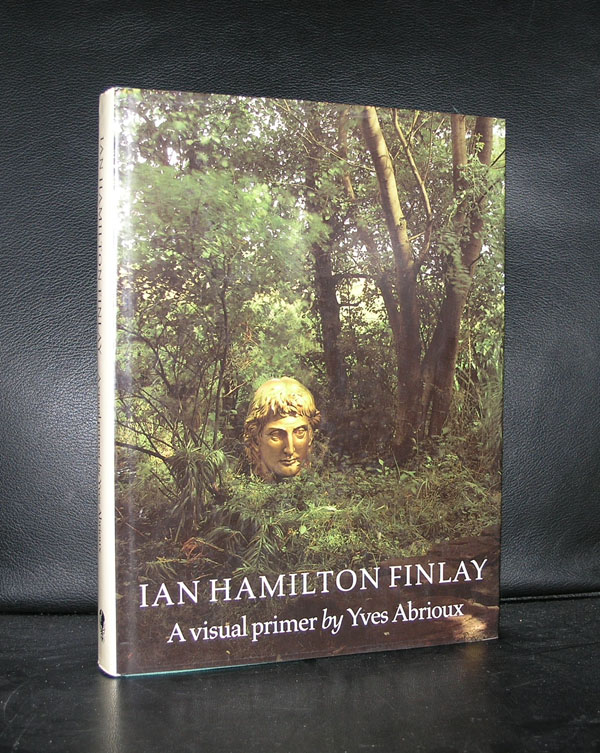 A book titled 'Ian Hamilton Finlay: A visual primer by Yves Abrioux' is displayed, featuring a head sculpture partially hidden in greenery.