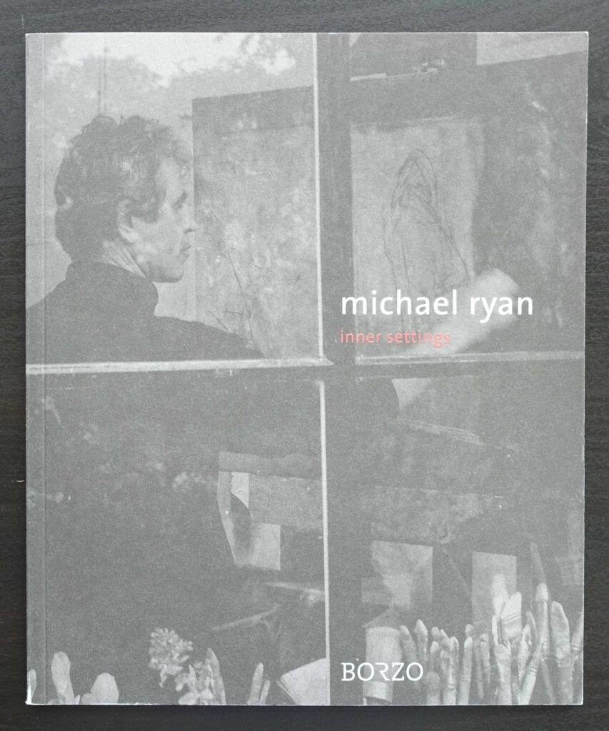 A book cover featuring a monochrome image of a man looking through a window with reflections, titled 'michael ryan: inner settings' by Borzo.