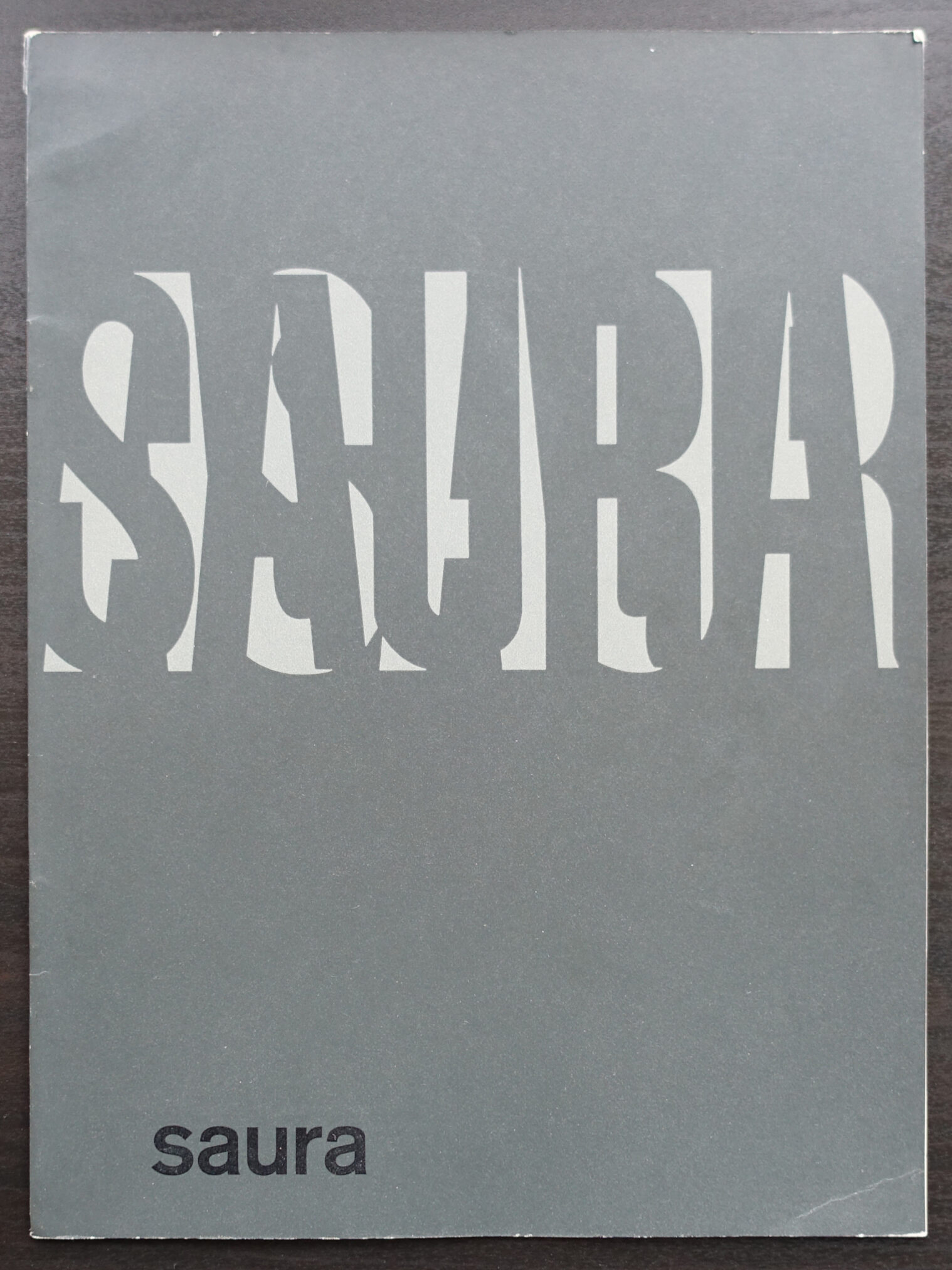 Cover of the 1960s catalog 'Saura' designed by Wim Crouwel, featuring bold, modernist typography and a minimalist aesthetic.