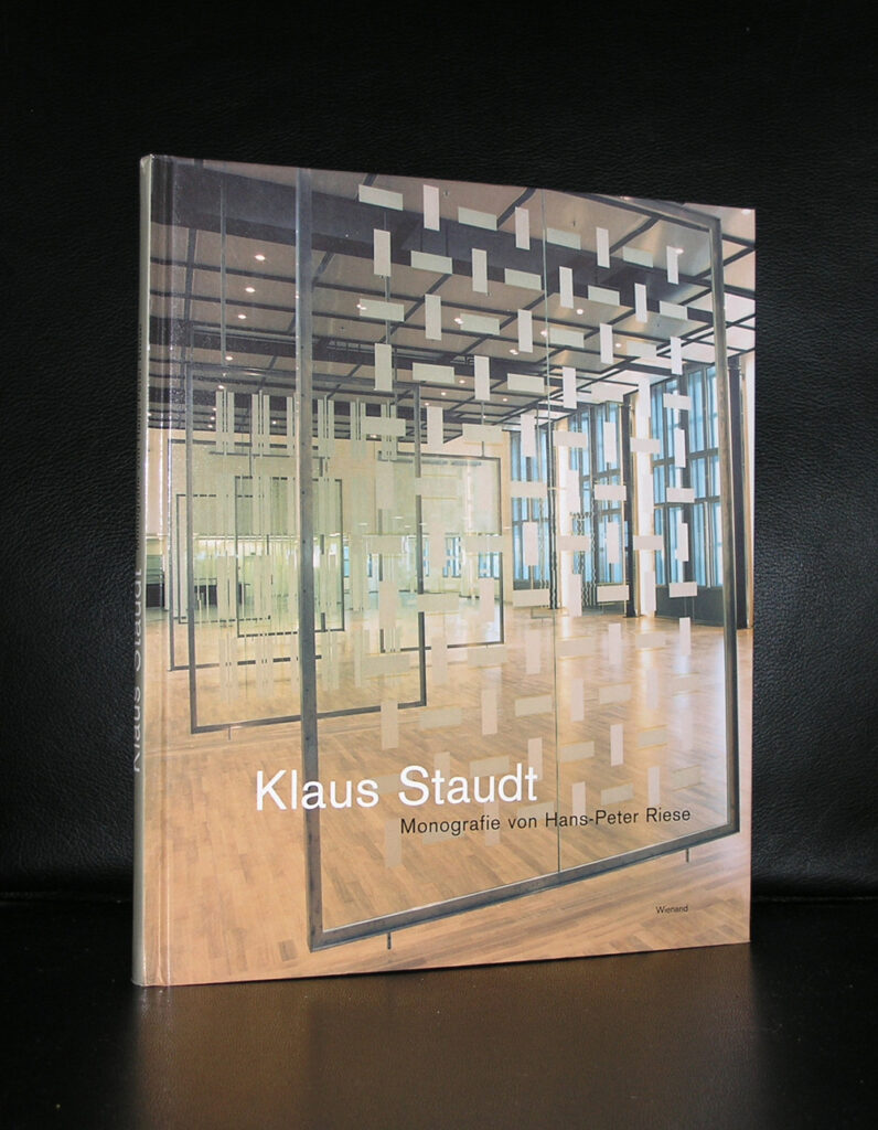 Cover of a book titled 'Klaus Staudt' featuring a geometric art installation in a well-lit gallery space.