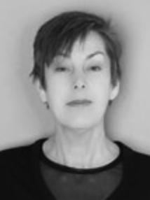 A black and white portrait of a woman with short hair, facing directly at the camera with a neutral expression.