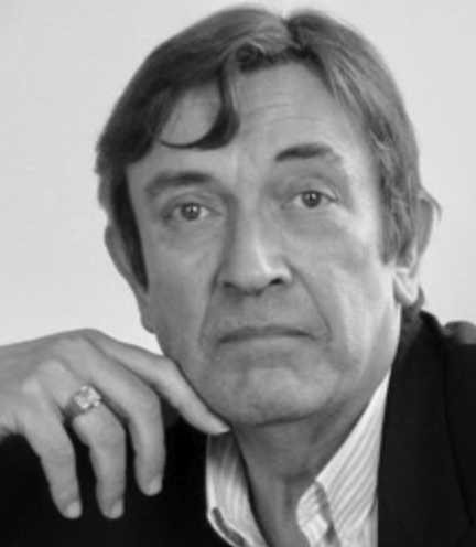 Black and white portrait of a man with a thoughtful expression, resting his chin on his hand.