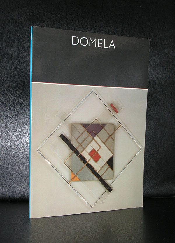 Cover of a publication titled 'DOMELA' featuring a geometric abstract art piece with various shapes and colors against a neutral background.