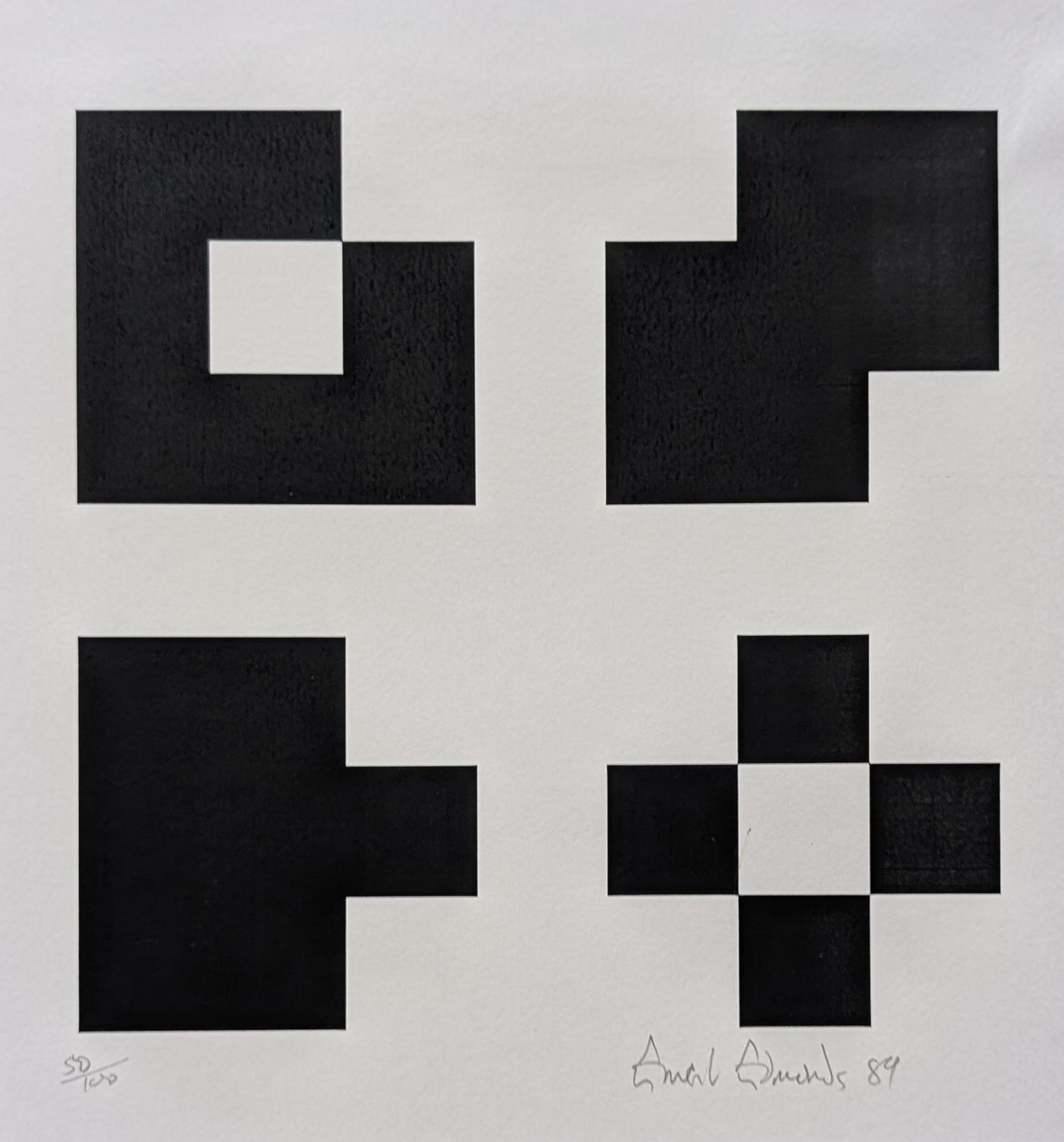 A minimalist artwork featuring four geometric shapes in black on a white background, created by Ernest Edmonds in 1989. The shapes vary in design and size, showcasing a combination of squares and rectangles.