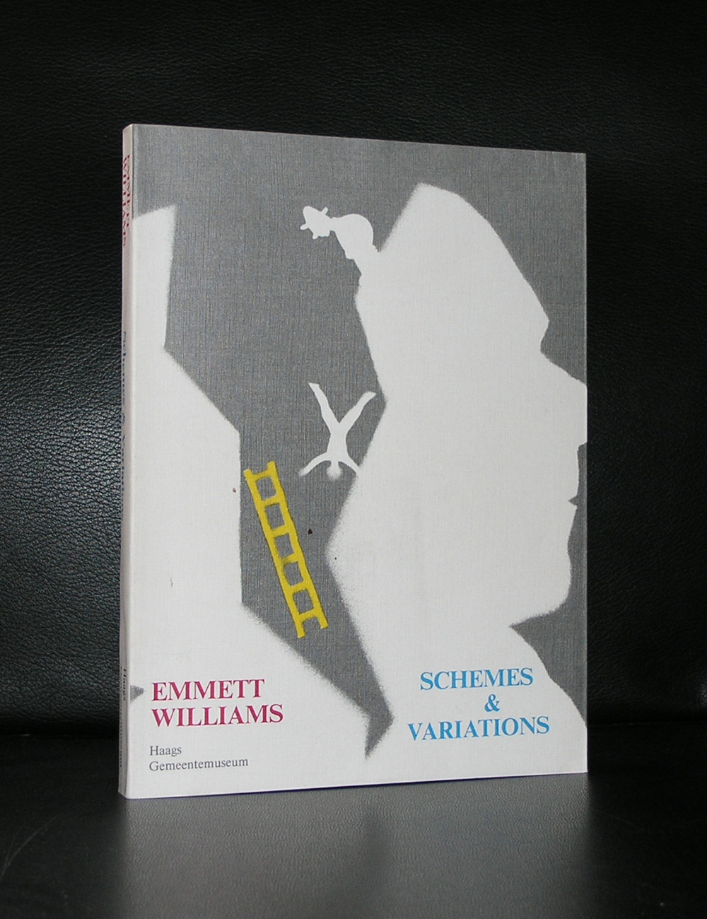 Book cover featuring the title 'Schemes & Variations' by Emmett Williams, showcasing an abstract design with a silhouette and colorful elements.