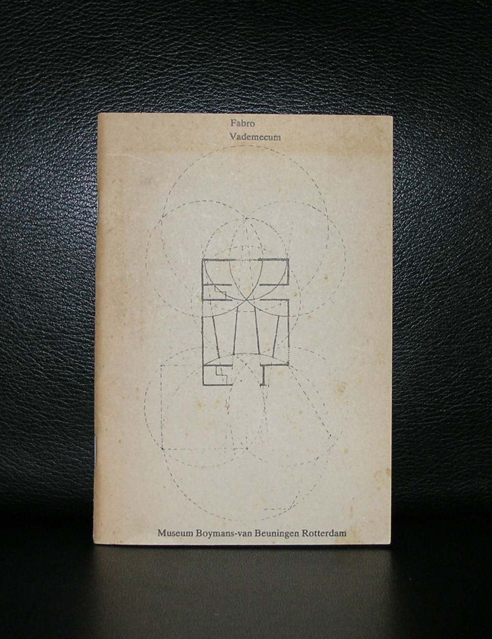 Cover of 'Fabro Vademecum' featuring a geometric drawing and text, resting on a black background.