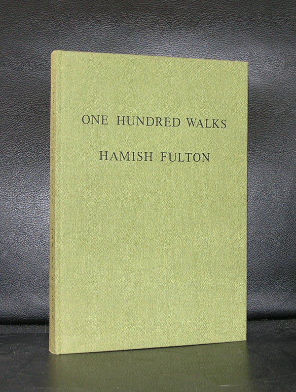 A hardcover book titled 'One Hundred Walks' by Hamish Fulton, displayed against a dark background.