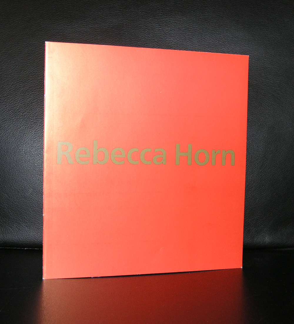 Cover of a publication featuring the title 'Rebecca Horn' in gold lettering on a red background, against a black surface.