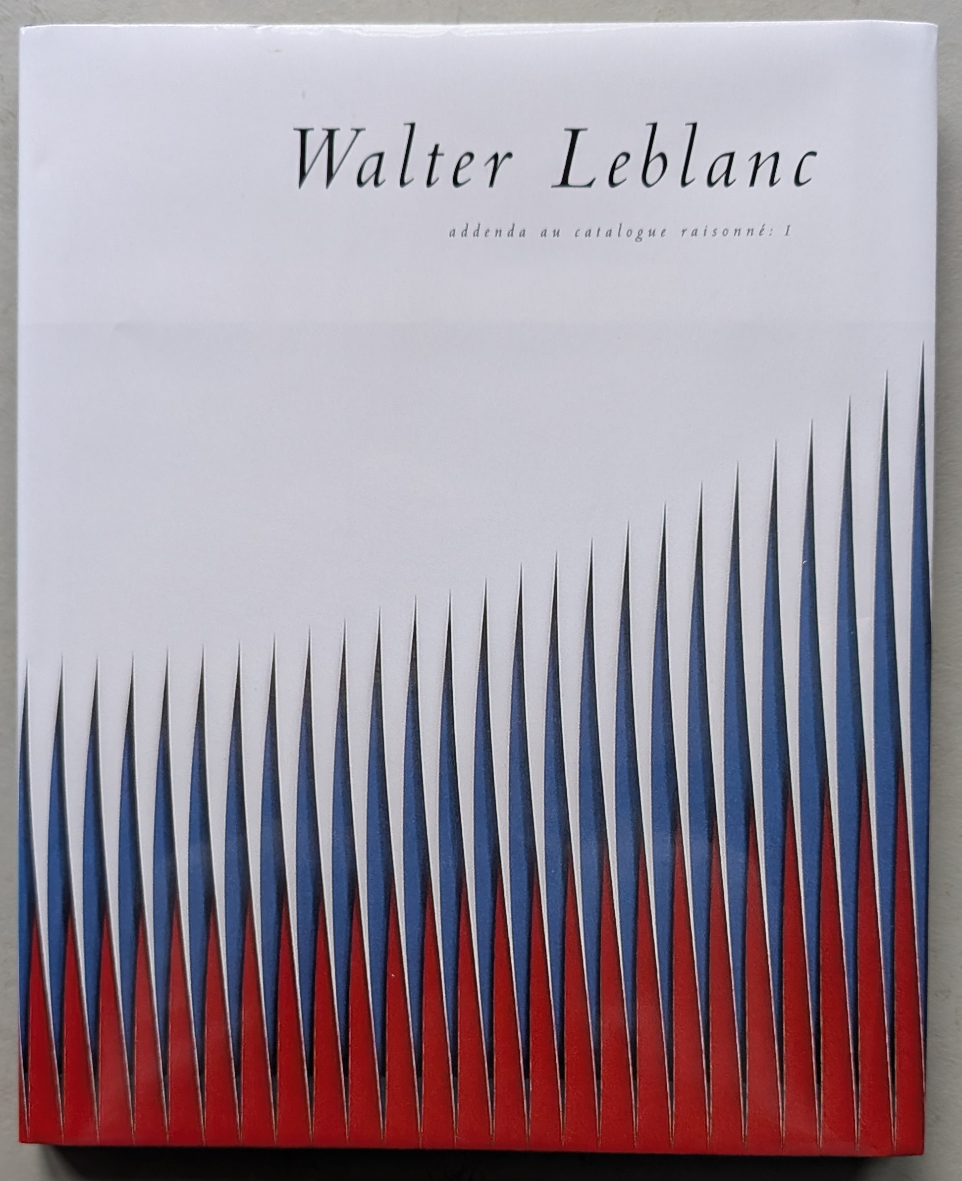 Book cover titled 'Walter Leblanc' featuring a design with blue, white, and red triangular shapes arranged in a dynamic pattern.