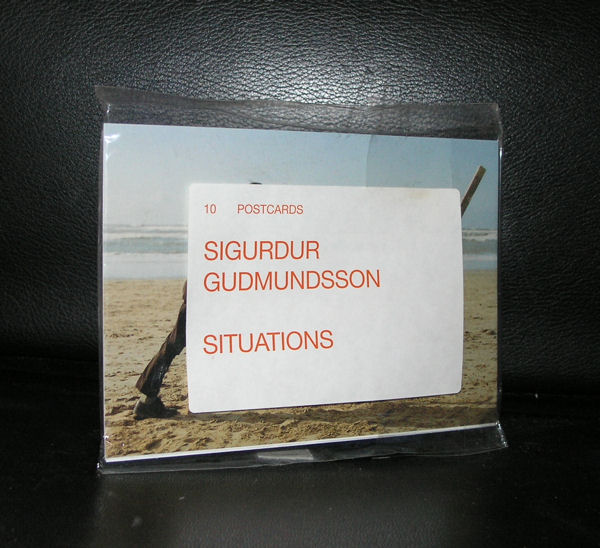 A set of postcards titled 'Sigurdur Gudmundsson Situations', displayed in a plastic sleeve against a black background.
