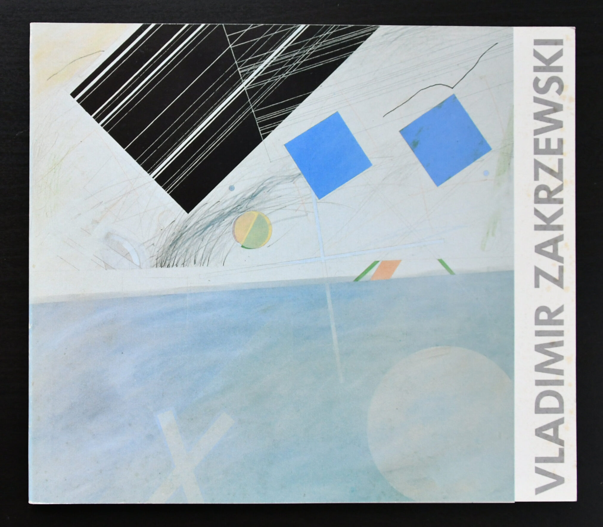 Cover of a publication featuring abstract art by Vladimir Zakrzewski, showcasing geometric shapes including squares and circles, along with dynamic lines on a light background.