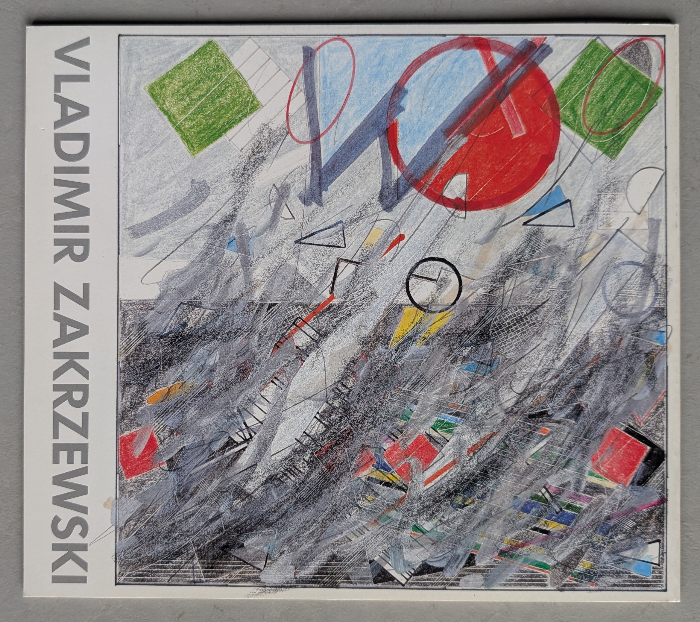 Cover of a publication featuring abstract artwork by Vladimir Zakrzewski, with geometric shapes and vibrant colors on a textured background.